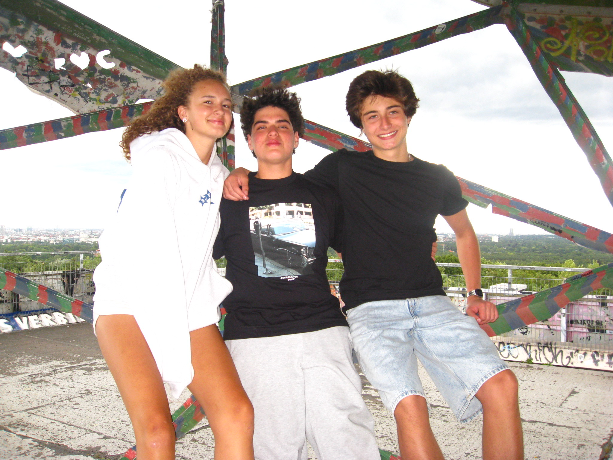 Three exchange students together above the Berlin skyline